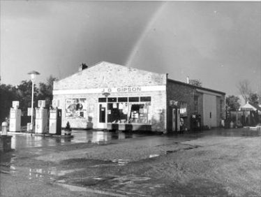 The garage and filling station in the 1960's. The chimney of Woolpack Cottage can just be seen to the left of the garage. This was demolished in the mid 1960's