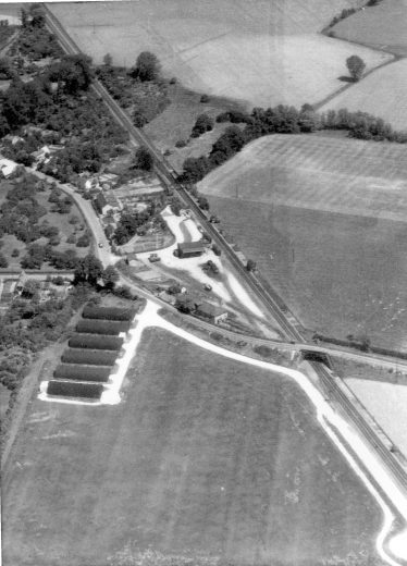 Aerial photo taken on June 21st 1949 clearly showing the six, black Nissen huts and the roadway beside the railway siding for the transfer of wounded soldiers from the ambulance trains to the waiting ambulances.  The first of the two turning circles can be seen in the bottom left hand corner of the photograph. | Cambridge University Air Photograph Library