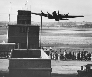 A World War II bomber takes off over the Bassingbourn airfield tower | Tower Museum, Bassingbourn