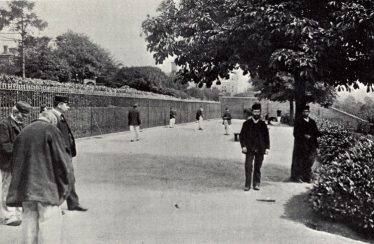 The Terrace at Broadmoor, c. 1908. The patients are wearing the distinctive Asylum clothing of dark blue jackets and grey trousers.  Their clothes and shoes were made on site. | Berkshire Record Office