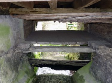 The mill race showing the pentrough and wheel axle, May 2017 | Photograph by Kathryn Betts