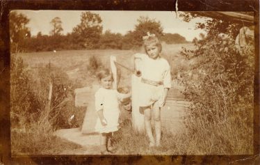 Evelyn, Sylvia and Norman (can you see him?) in a field near Meldreth Church in the 1920's | Sylvia Gipson