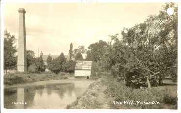 Flambards Mill after the fire, showing the wheel housing where Ken fished for sticklebacks and the chimney where he lit a fire | Bell's Postcard supplied by Ann Handscombe