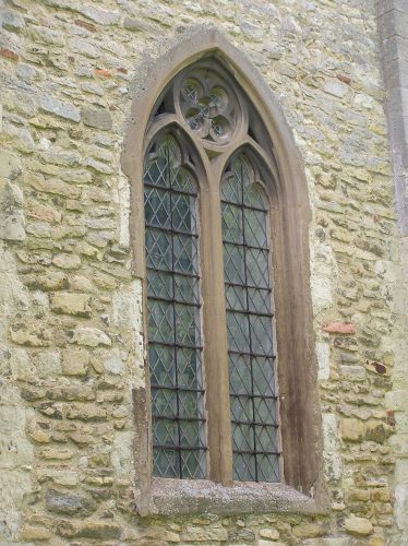 The opresent window is entirely 19th century but may follow fairly faithfully a late 13thc window which must have been inserted into the west face of the tower when the upper stage was built. The quatrefoil is now enclosed within a circle and the bars of stone have become thinner. The opresent window is entirely 19th century but may follow fairly faithfully a late 13thc window which must have been inserted into the west face of the tower when the upper stage was built. The quatrefoil is now enclosed within a circle and the bars of stone have become thinner. | Peter Draper