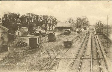 Photograph of the Goods Yard at Meldreth Station ~1925 - 35. The large warehouse is on the extreme left of the photograph. Photograph of the Goods Yard at Meldreth Station ~1925 - 35. The large warehouse is on the extreme left of the photograph. | Postcard, photo by J Bishop