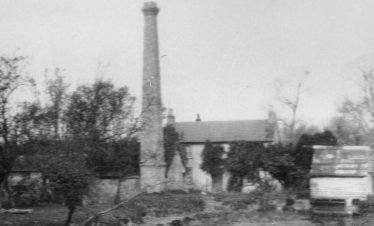 Flambards Mill after the fire, with Mr Sheldrick's farmhouse in the background | Photograph courtesy of Sandra Webb