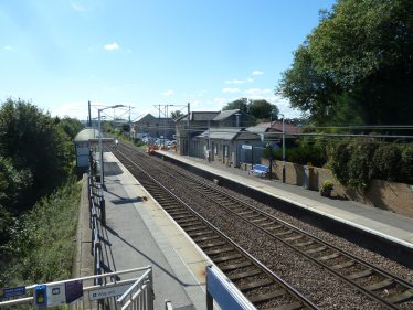 Photograph, taken in 2017, showing the railway line, station and land occupied by the old goods yard elevated above the surrounding land. | Tim Gane