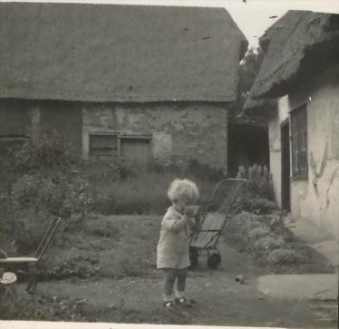 Roger Winter in Jarman's Yard ~1940 - 45.  Orchard Cottage is to the right with Bramble Cottage in the background | Roger Winter