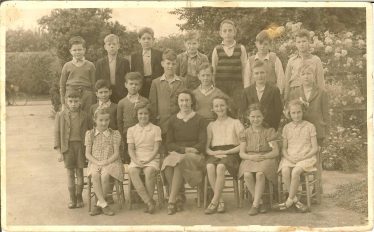 Class 2 of Meldreth School, pictured in 1946.  Ken Winter is second from the right in the back row.  Miss Broughton is in the front row. | Photograph courtesy of Ken Winter