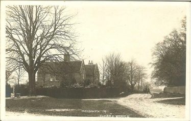 The stocks, c. 1905 with Meldreth Manor House in the background | Robert H Clark postcard supplied by Brian Clarke