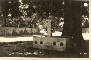 The stocks and whipping post, 1920s | Bell's Postcard