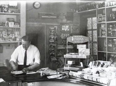 Postmaster Mr Walter Reed working in the Post Office, High Street, Meldreth.  c. 1965 | Photo supplied by Meldreth W.I.